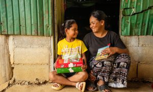 TOLA CONTINUES TO SHARE JESUS CHRIST WITH HER MOTHER, AT TIMES USING THE GREATEST GIFT GOSPEL BOOKLET SHE RECEIVED WITH HER SHOEBOX GIFT.